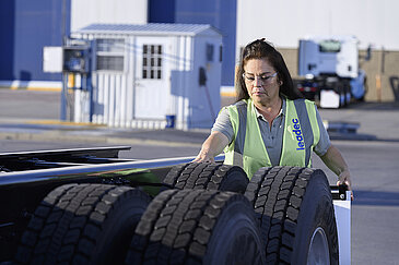 Female Leadec employee checking tyres.
